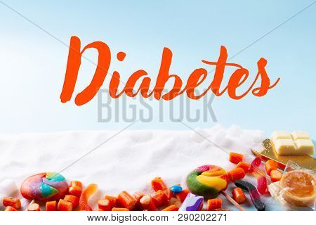 Sweets And Candies With Sugar, On Blue Background With Word Diabetes