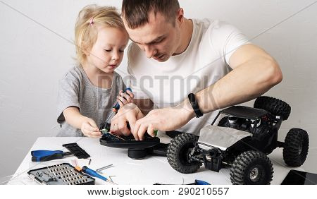 Family Time: Dad And Daughter Repair The Rc Radio Controlled Buggy Car Model And Lead A Video Blog.