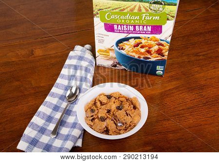 Atlanta, Georgia - April 19, 2017:  A Box Of Cascadia Farm Raisin Bran With A Bowl Of Cereal And Mil