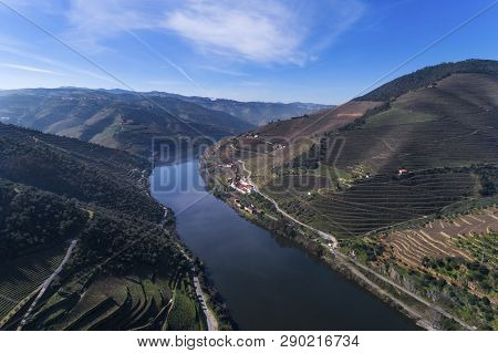 Aerial View Of The Terraced Vineyards In The Douro Valley And River Near The Village Of Pinhao, Port