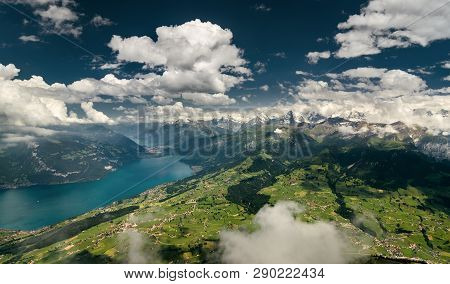 Aerial Shot Of Bernese Alps, Lush Valley And Lake Thun, Berner Oberland, Switzerland.