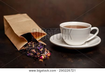 Elicious Tea In A White Mug, Scattered Tea From The Package On A Stone Background