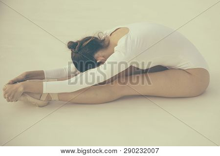 Training Her Flexibility. Ballet Dancer Doing Stretching Exercise. Ballerina In Ballet Class. Pretty