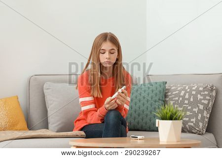 Teen Girl Using Lancet Pen At Home. Diabetes Control