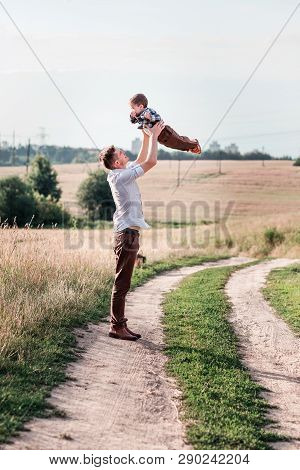 Father Toss Up His Son . Vertical Photo
