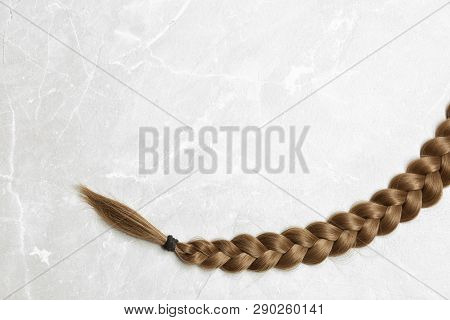 Braided Hair On Grey Background, Top View With Space For Text
