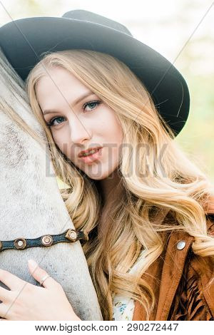 Beautiful  Young Girl With Blond Hair In A Suede Jacket With A Fringe , Wearing Black Floppy Hat, Sm