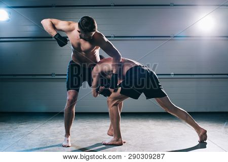 Strong Muscular Shirtless Mma Fighter Punching Another While Man Doing Clinch