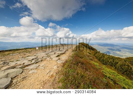 Hiking trail to Mala Babia Gora Mountain from Przelecz Brona Pass in Polish Beskid. High mountains landscape under blue sky with clouds.