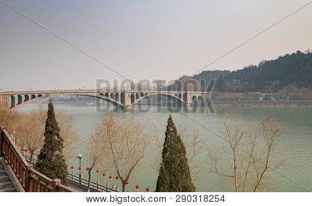 The Walk Way Along And The Bridge With The Chinese Style At The Longmen Grottoes. The Longmen Grotto