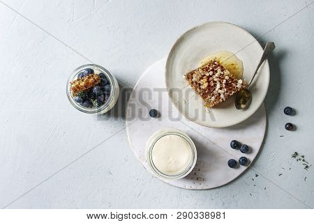Homemade Classic Dessert Panna Cotta With Blueberry Berries In Jars, Decorated By Mint, Thym, Honey 
