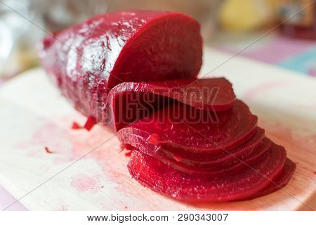 Slicing Of Boiled Beet For Salad On Wooden Cutting Board Closeup Tasty