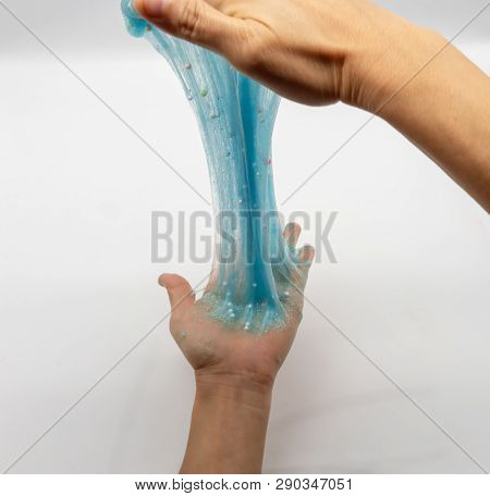 Hand Strecthing Transparent Blue Glitter Slime Isolated On White