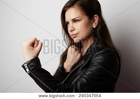 Fashion Photo Of A Beautiful Brunette Woman Wearing Leather Jacket With Dark Long Hair Posing Over W