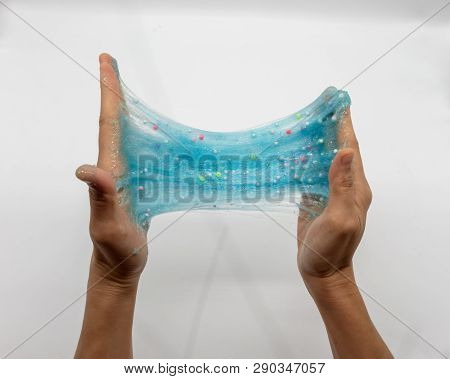 Hand Strecthing Transparent Blue Glitter Slime Isolated On White