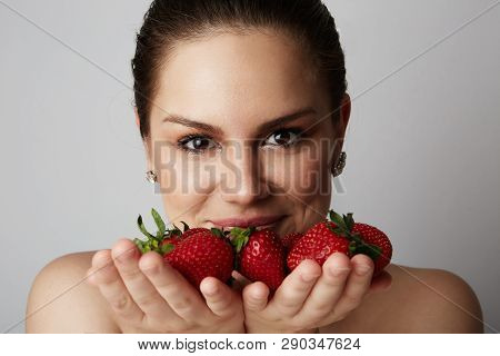 Pretty Happy Smiling Girl With Many Strawberry Over Colorful White Background.portrait Of Brunette C