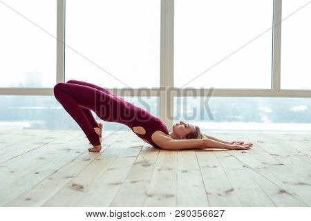 Peaceful And Calm Well-trained Girl Party-lying On Wooden Floor