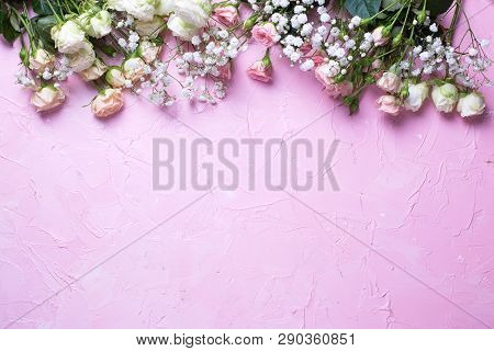 Border From Fresh White Gypsofila And White Rose Flowers On  Pink Textured Background. Top View. Pla