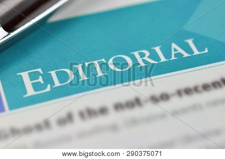 Heading A Editorial In The Newpaper. Concept Editorial. Shallow Dof.