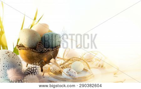 Easter Greeting Card With Colorful Easter Eggs And Sprin Flowersl On Blue Table