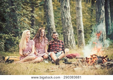 Camping Travel And Wanderlust. Bearded Man And Women Smile At Bonfire. Happy Friends At Campfire. Hi