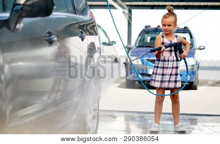 Little Girl Washing Auto In Self-serve Car Wash