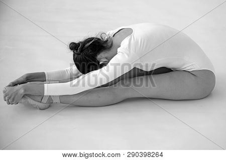 Training Her Flexibility. Ballet Dancer Doing Stretching Exercise. Ballerina In Ballet Class. Pretty