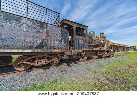 Encarnacion, Paraguay - November 14, 2018: Old Rusted Steam Locomotive In Encarnacion. In Paraguay T