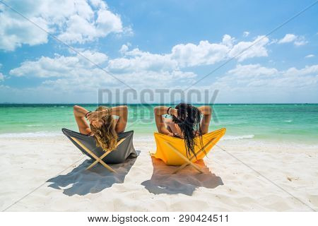 Two Women enjoying their holidays on a transat at the tropical beach in Thailand