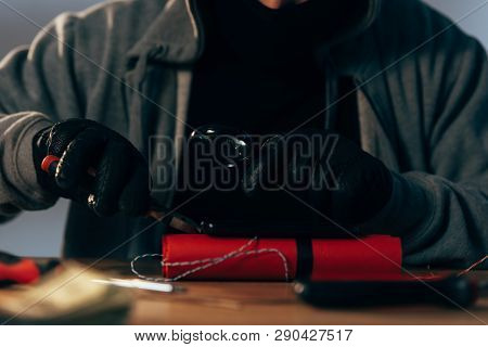 Partial View Of Terrorist In Leather Gloves Making Bomb