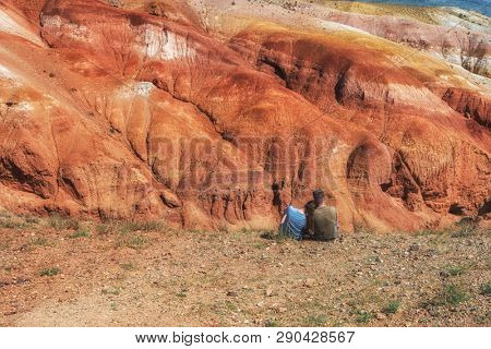 Relaxing man and woman in Valley of Mars landscapes in the Altai Mountains, Kyzyl Chin, Siberia, Russia