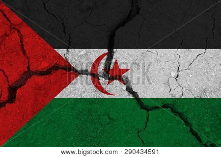Sahrawi Arab Democratic Republic Flag On The Cracked Earth. National Flag Of Sahrawi Arab Democratic
