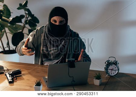Angry Terrorist In Black Mask Gesturing At Webcam In Room