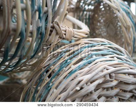 Empty Wicker Baskets With The Handle. Hang On A Column In Shop. White Baskets