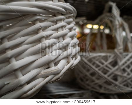 Empty Wicker Baskets With The Handle. Hang On A Column In Shop. White Baskets