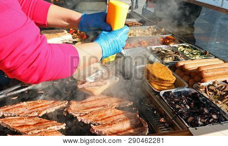 Chef And Cooked Sausages In The Kiosk Of Street Food