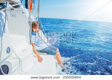 Little Boy On Board Of Sailing Yacht On Summer Cruise. Travel Adventure, Yachting With Child On Fami