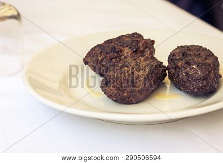 Fried Minced Meat Of Horsemeat, Traditional Sicilian Lunch On A White Plate In A Restaurant Of Catan