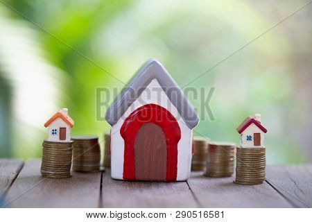 Mini House On Stack Of Coins,money And House,  Mortgage, Savings Money For Buy House And Loan To Bus