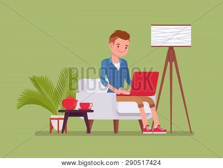 Young Male Employee Working From Home. Happy Freelance Worker, Self-employed In Comfortable Remote L