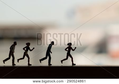 Miniature People Is Running , Silhouette Of A Runner , Health And Lifestyle Concepts.