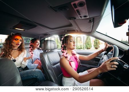 Trendy, Stylish, Trendy Girlfriends Go In The Car Listening To Music And Having Fun Together. They G