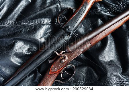 Pair Of Ancient Hunting Shotguns Closeup On Leather Background