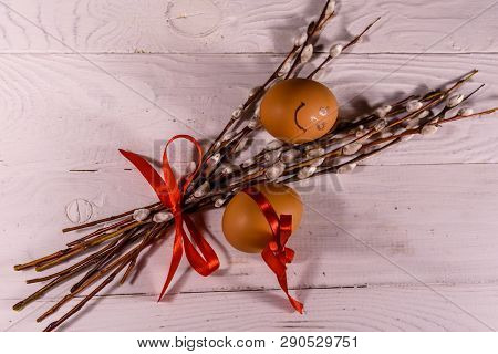Pussywillow Bouquet And Easter Eggs On White Wooden Table.