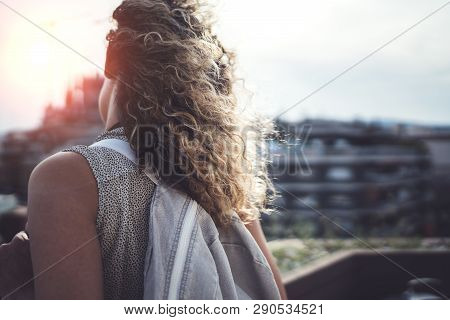 Hansome Young Woman Curly Hair And Casual Wear Enjoing Beautiful View Of The City On Sunset.