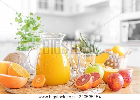 Multifruit Juice And Fresh Fruit On Table On Kitchen Background Closeup