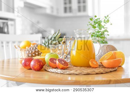 Multifruit Juice And Fresh Fruit On Table On Kitchen Background Closeup