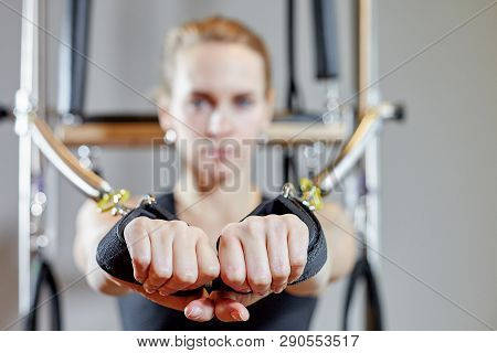 Gym Woman Pilates Stretching Sport In Reformer Bed Instructor Girl. Selective Focus On Hands