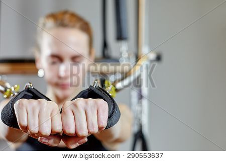 Gym Woman Pilates Stretching Sport In Reformer Bed Instructor Girl. Selective Focus On Hands