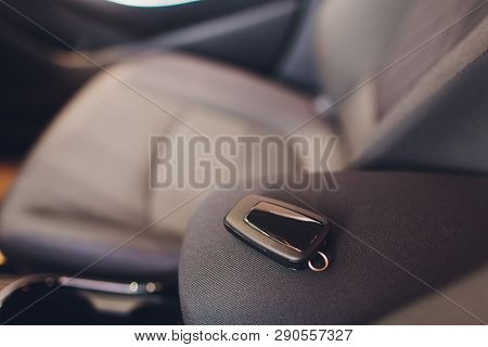 Closeup Inside Vehicle Of Wireless Key Ignition. Start Engine Key. Car Key Remote In Black Perforate